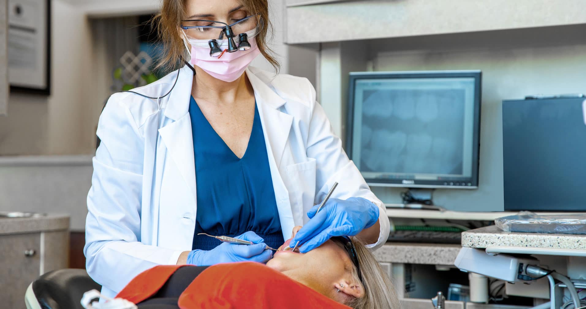 Dr. Maddox performing dental procedure on patient