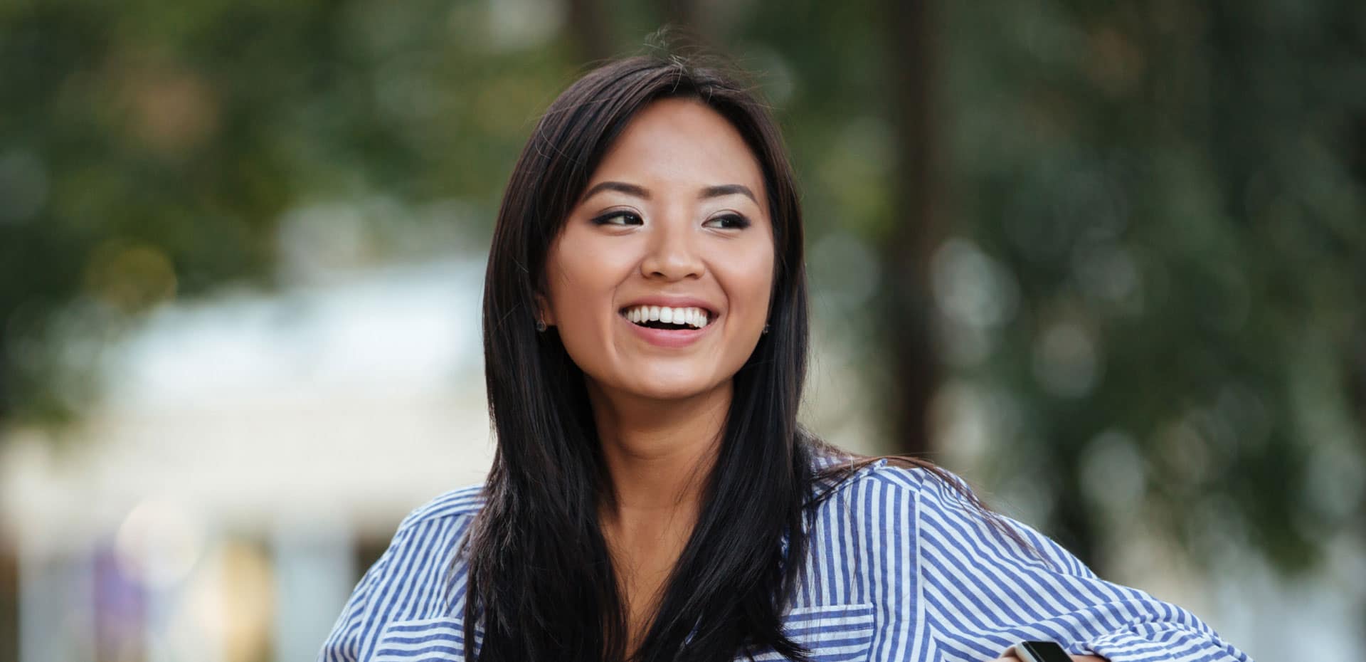 young asian woman sitting outside