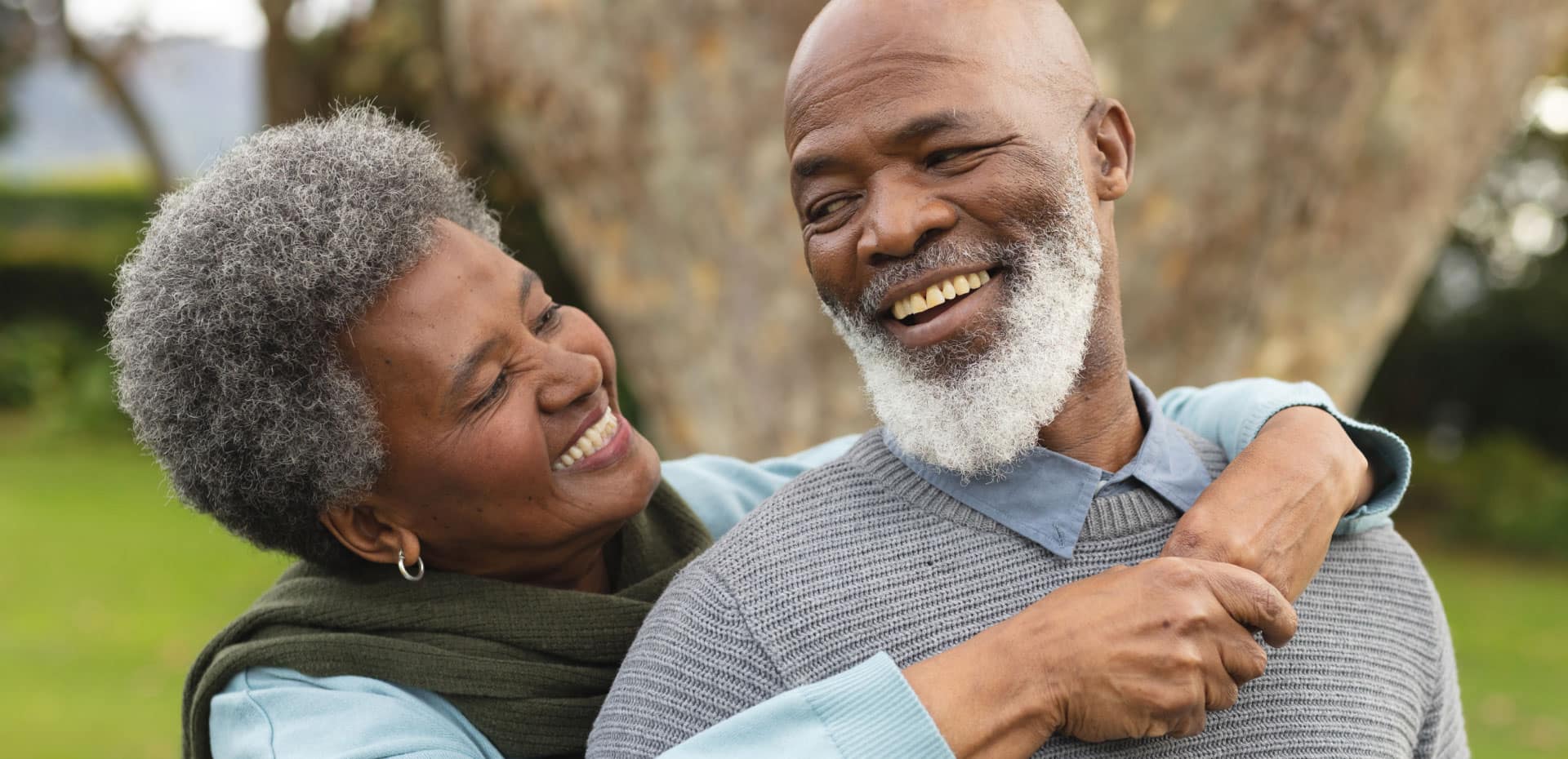 older black couple hugging outside