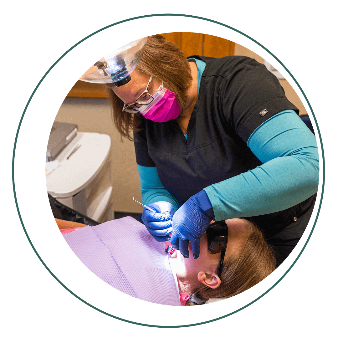 fillings-2 hygienist performing exam on pediatric patient