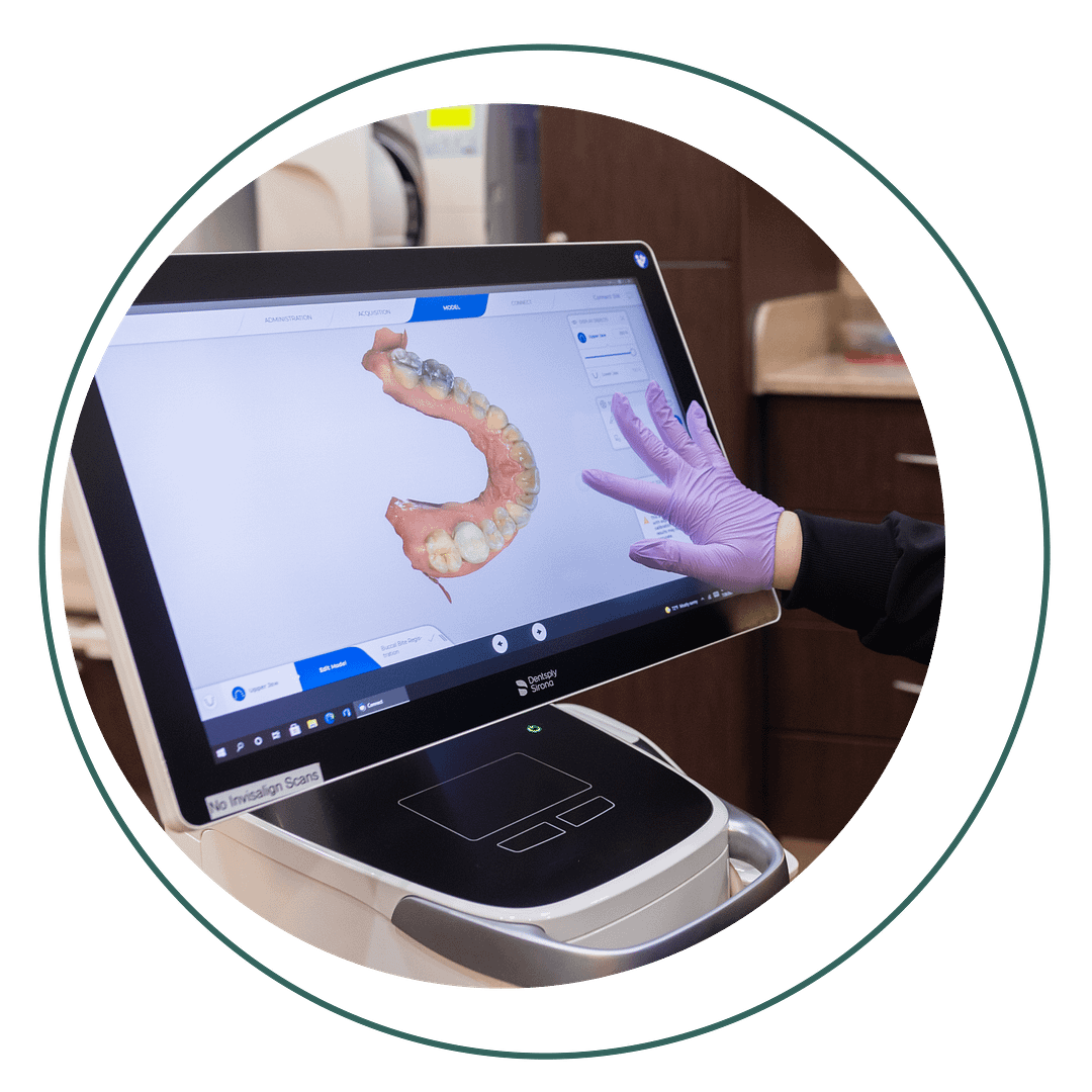 assistant looking at dental image on iTero machine