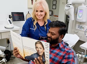 Dr. Harrison and patient reading through brochure about the Bioclear treatment provided in the office
