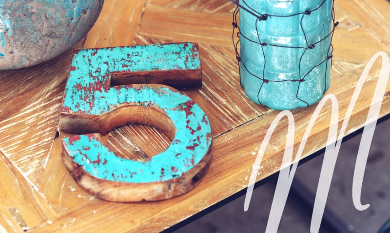 wooden "5", laying on a wood table