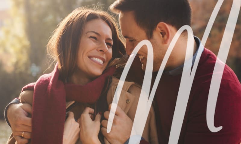 man and woman hugging and smiling