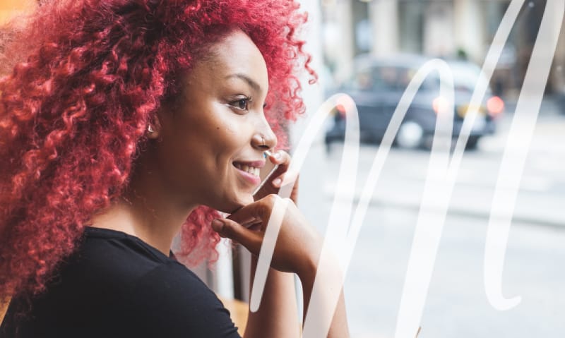 woman smiling and looking out the window
