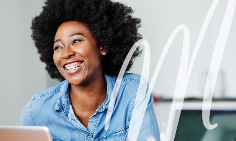 woman in blue denim shirt smiling