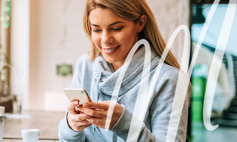 woman learning about veneers on her phone