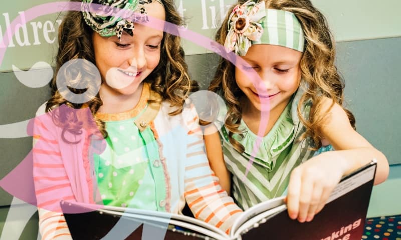 two girl patients reading a book