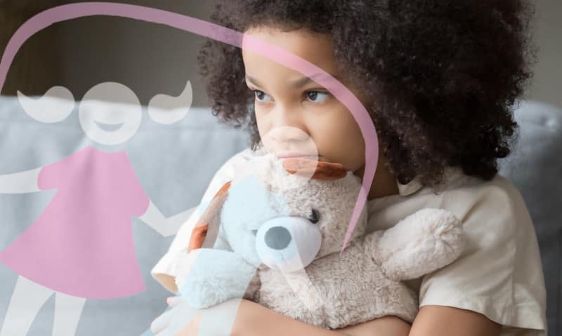 young girl holds her teddy bear