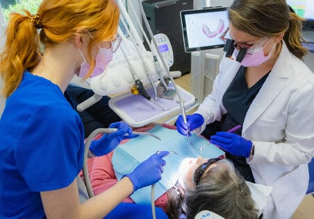 doctor and team member with patient in chair