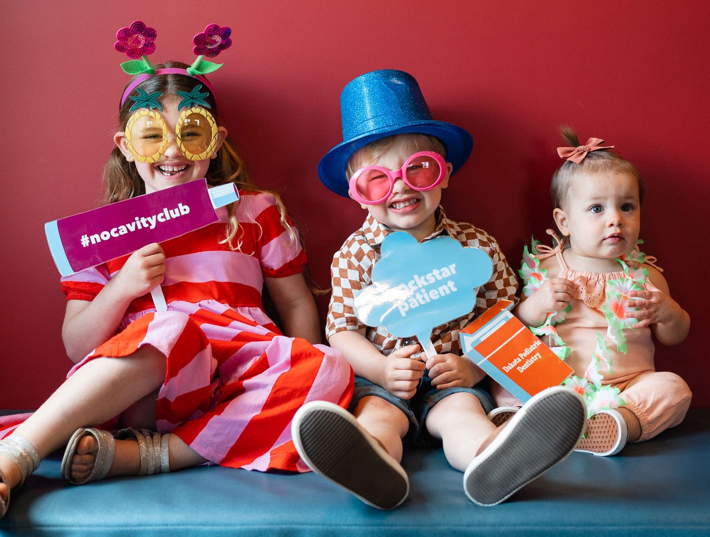 3 young patients dressed up in fun "no cavity club" costumes