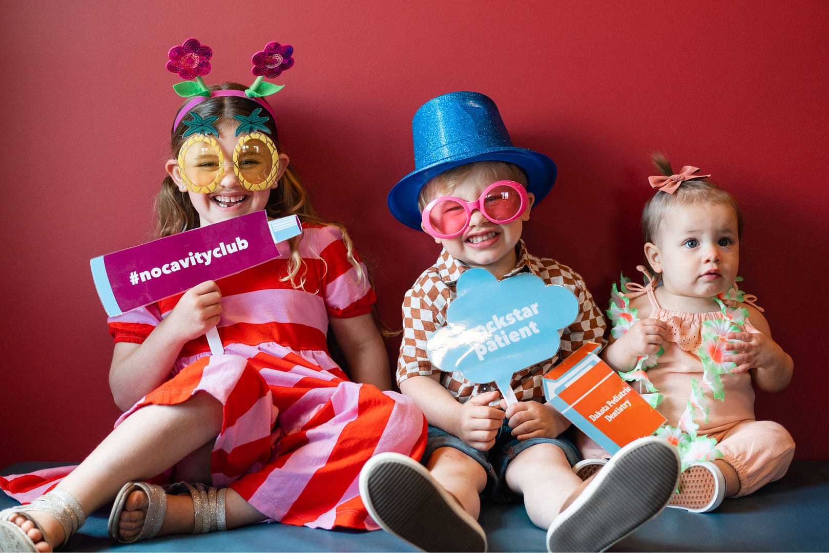 3 young patients dressed up in fun "no cavity club" costumes