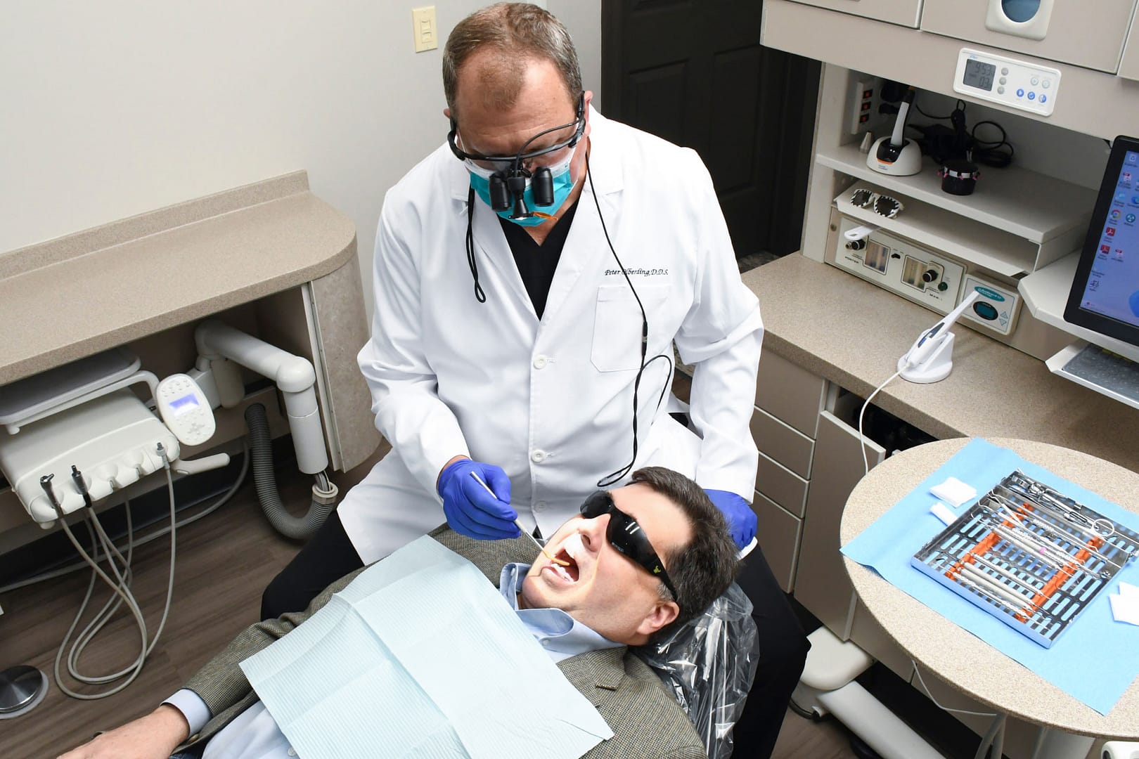 Dr. Olberding performing dental exam on patient in exam room