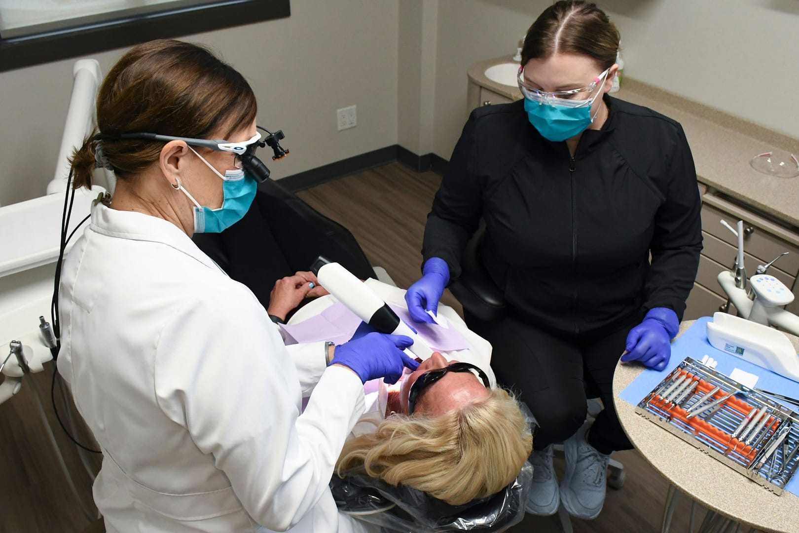 Dr. Holst and assistant using intraoral camera on patient in exam room