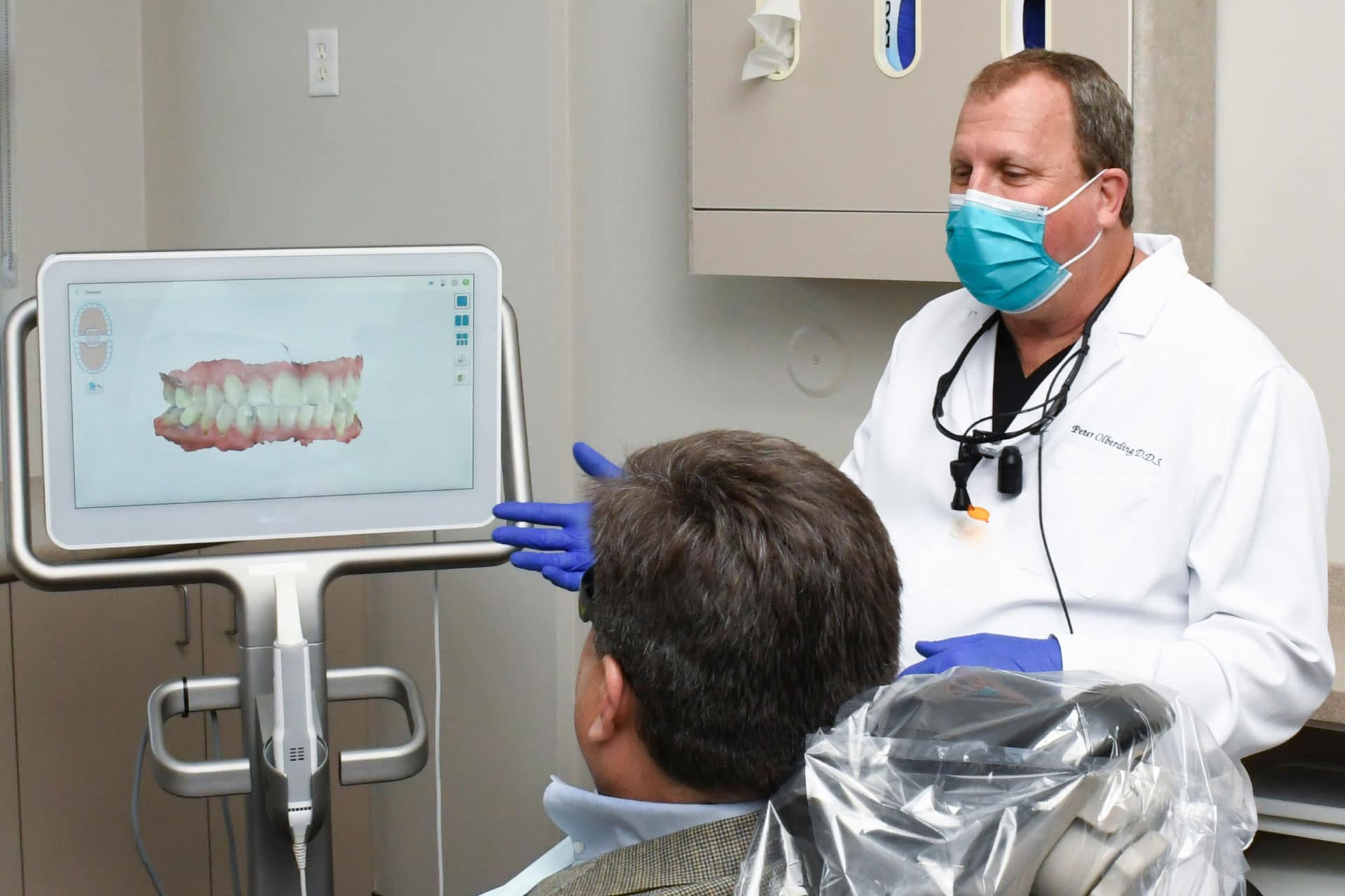 Dr. Olberding talking to patient about dental image on iTero machine screen