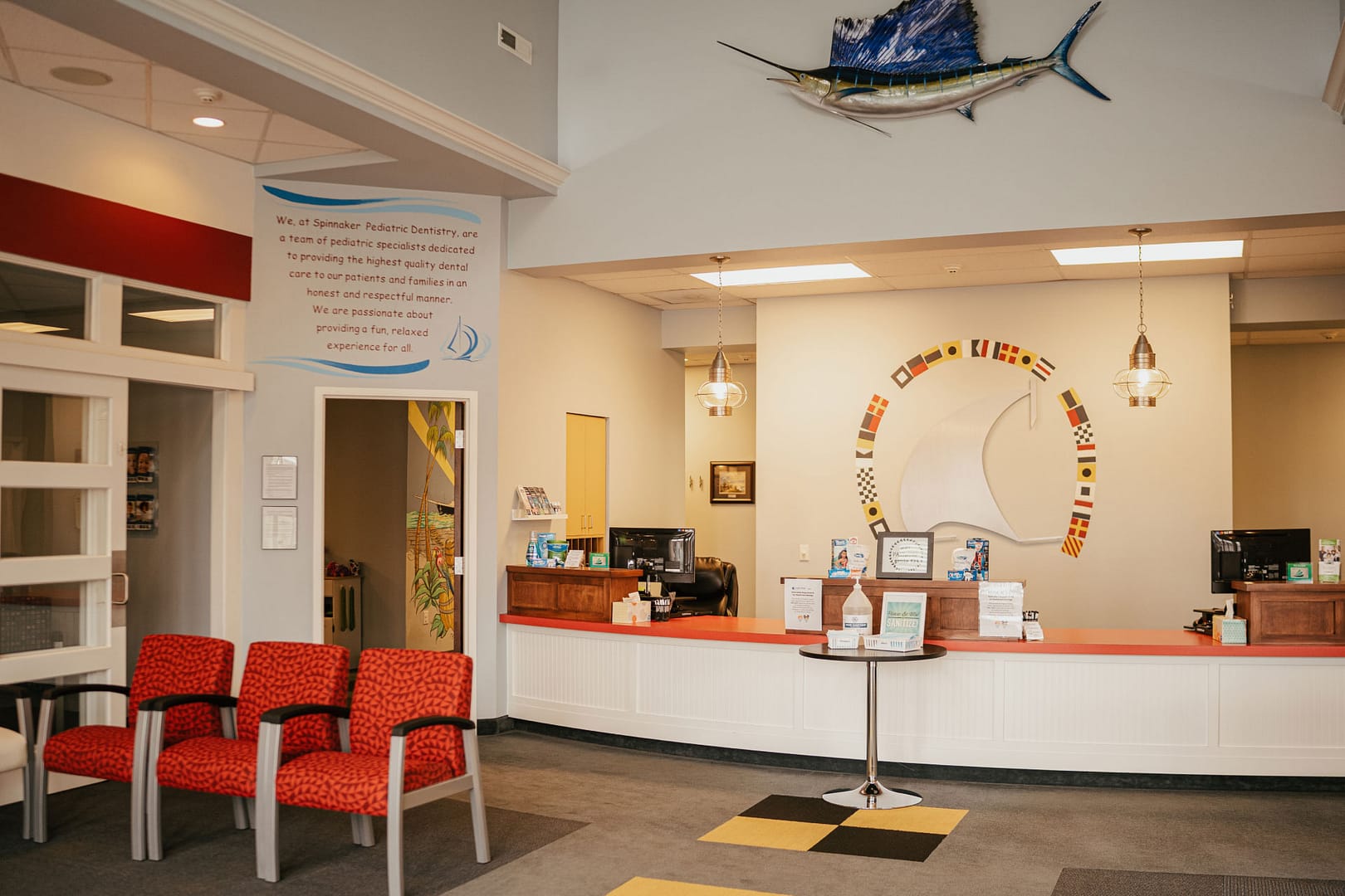 front desk with sailfish on wall above