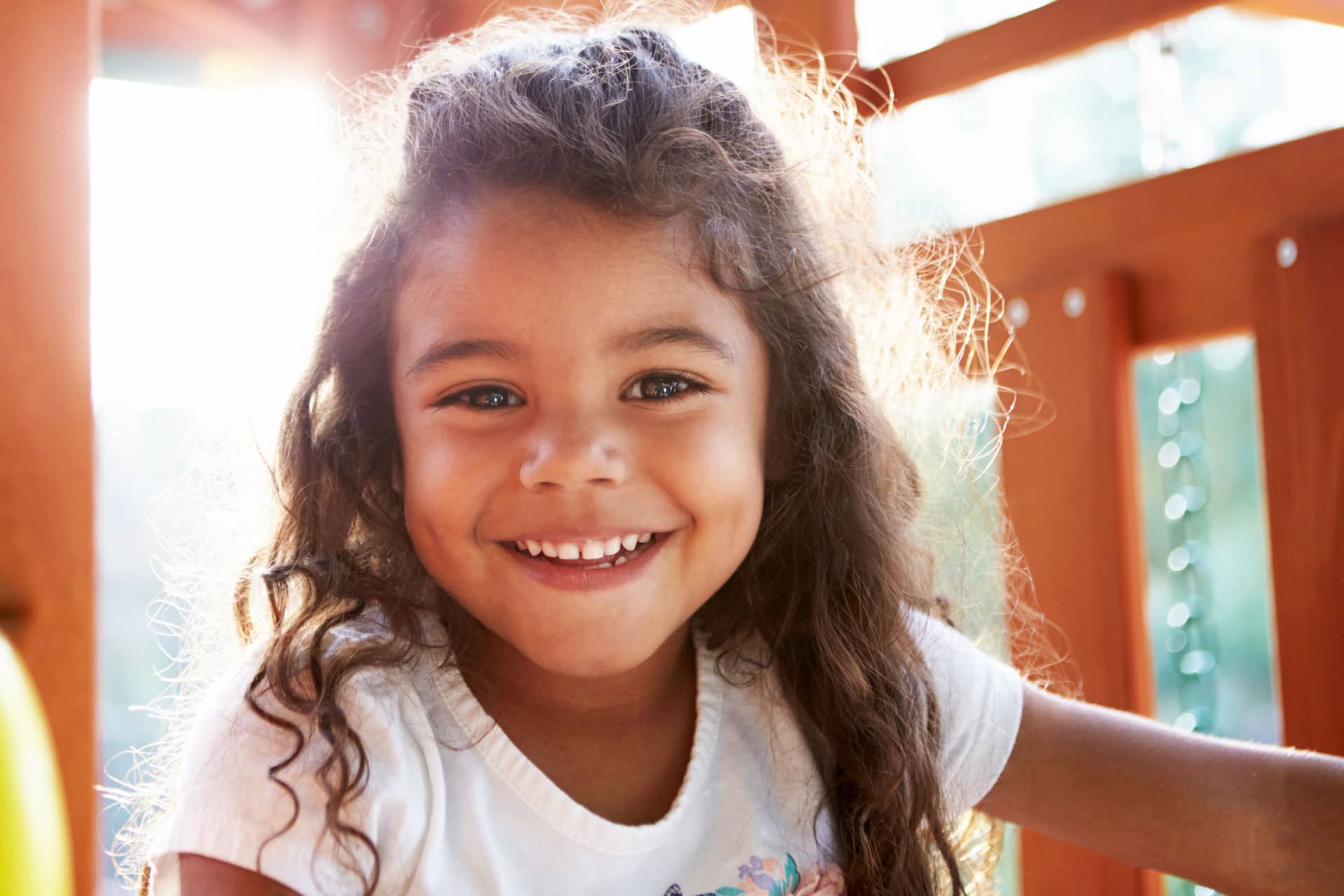little african american girl playing on playground equipment