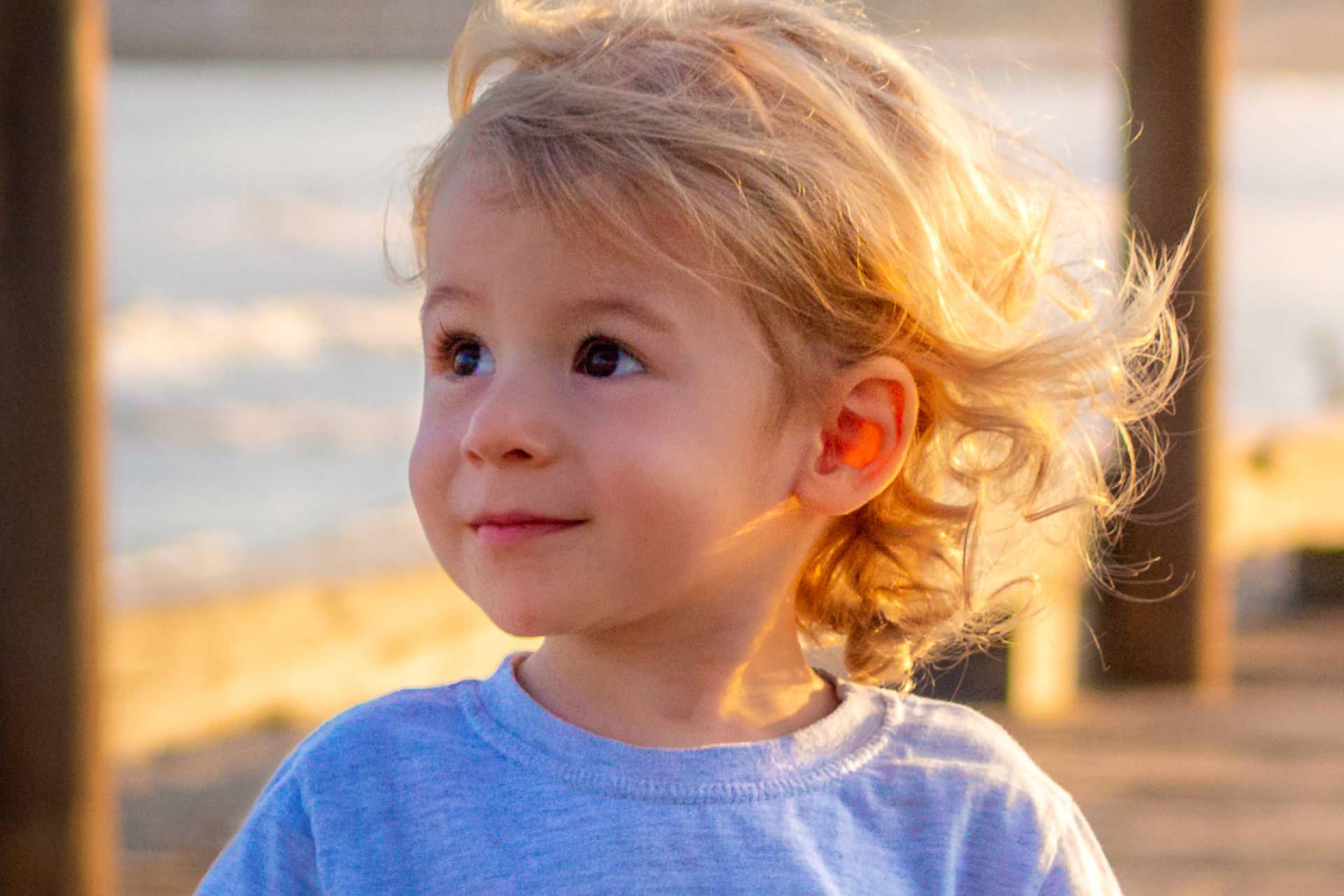 little caucasian boy smiling and looking left