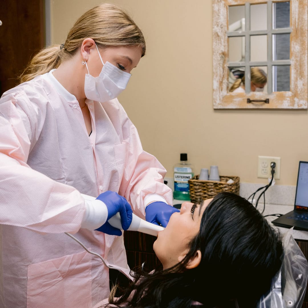 team member taking intraoral photos of patient