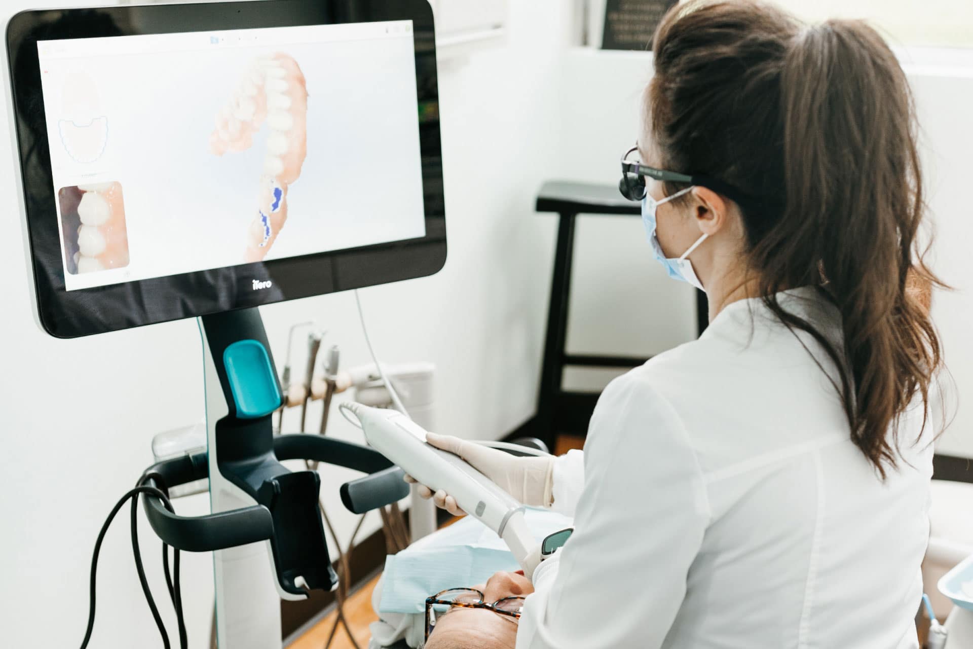 dental assistant using iTero scanner on patient