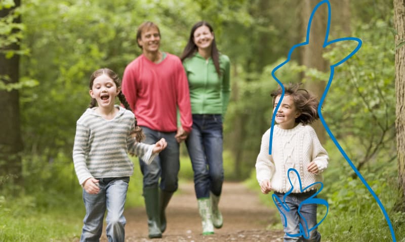 family going for a walk on a trail.