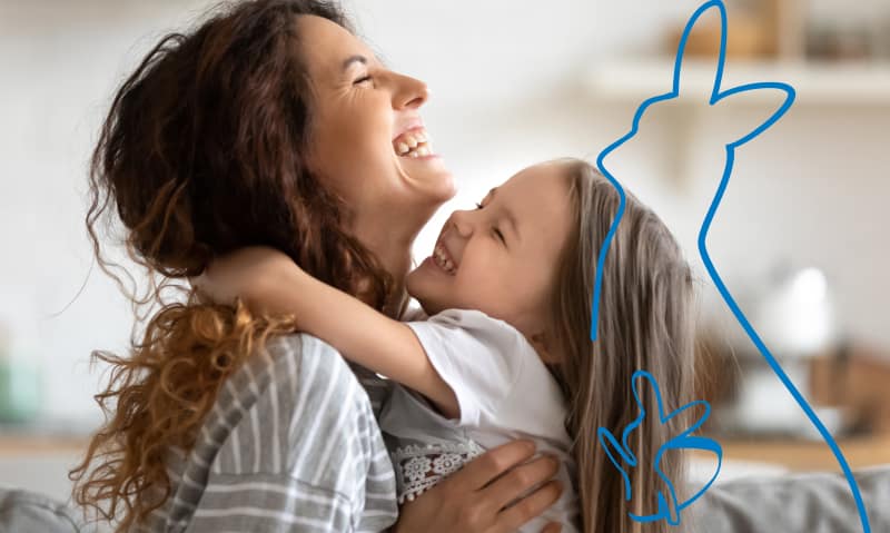 Mom and daughter laughing and hugging