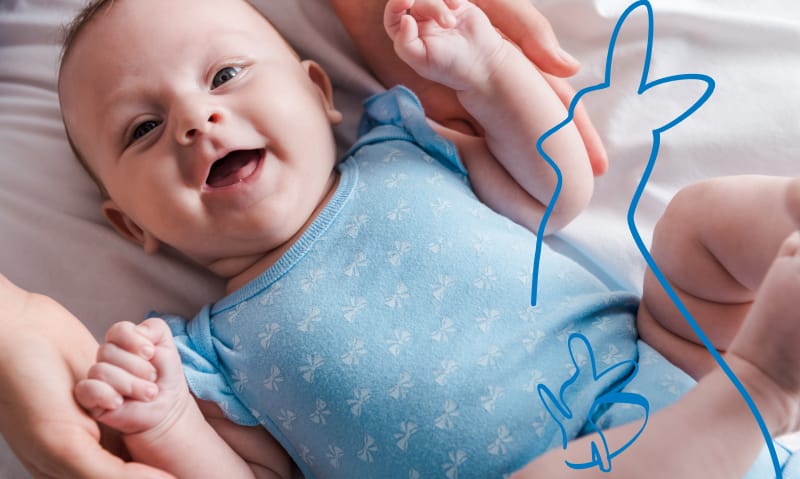 baby wearing blue onesie