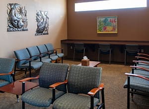 reception area with blue chairs and artwork on the walls