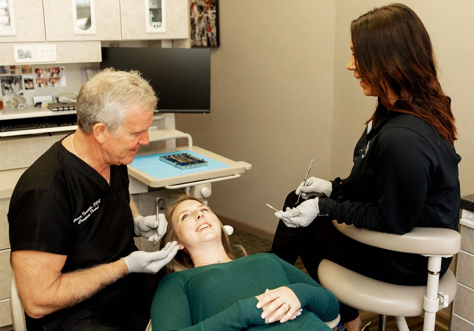 implants-home-feature Doctor with team member and patient in chair
