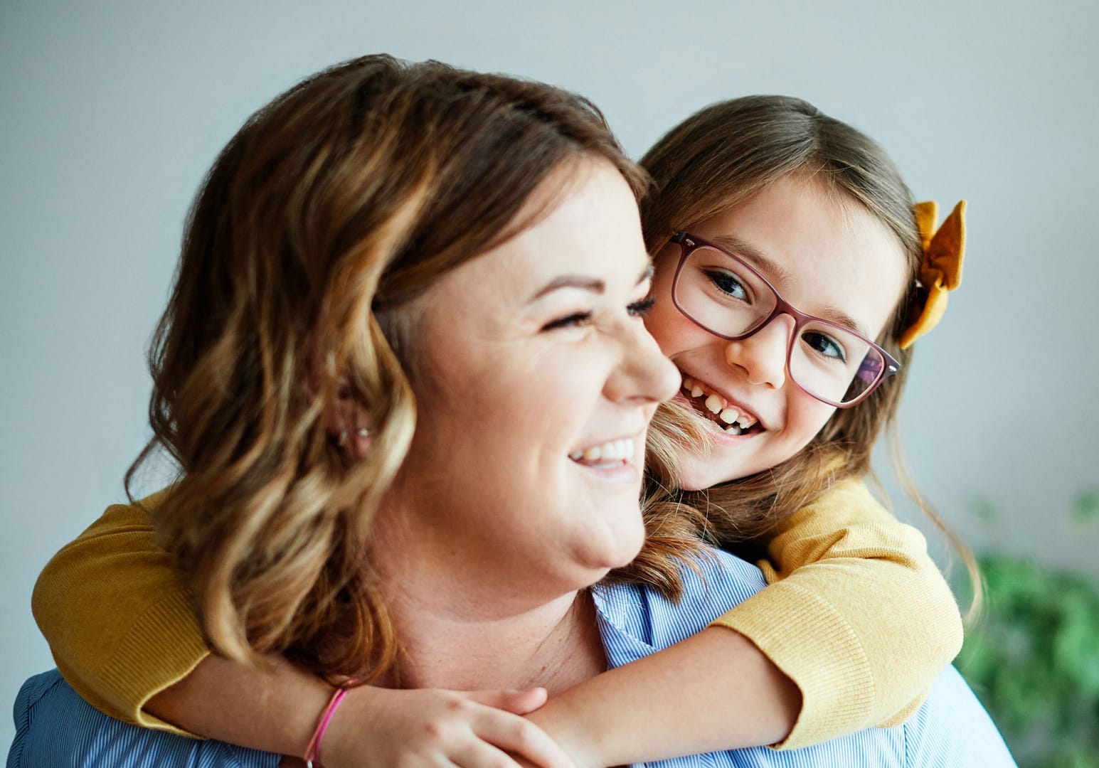 mother and daughter hugging and smiling