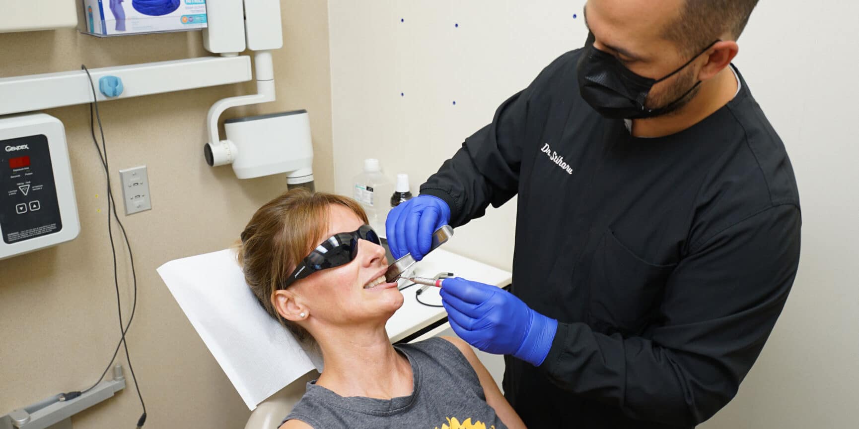 Dr. Stiharu performing dental exam on patient