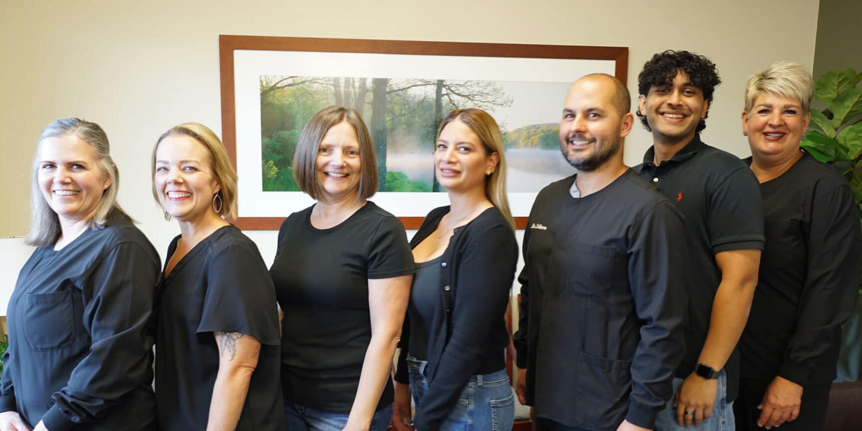 Metro Dentalcare Burnsville team posing for photo in reception area
