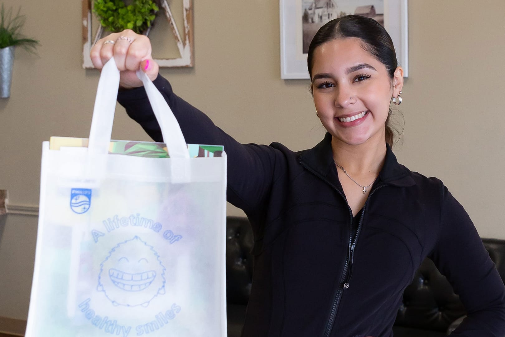 welcome-main team member holding goodie bag