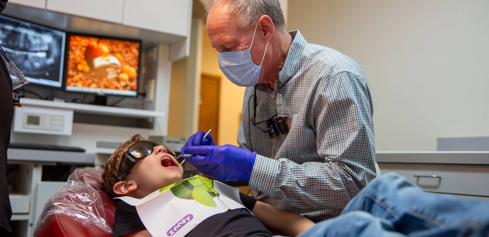 general-hero Dr. Spencer performing dental procedure on young patient